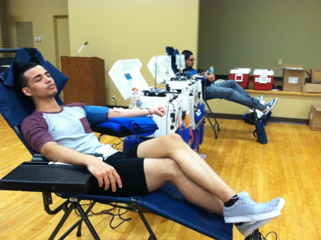 Usloy Reyna Cavasos and Jorge Martinez II relax while donating blood