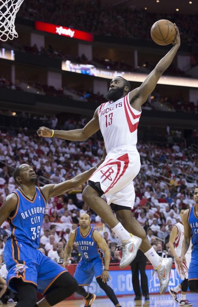 James Harden (13) of the Houston Rockets goes for a dunk against Kevin Durant (35) of the Oklahoma City Thunder.