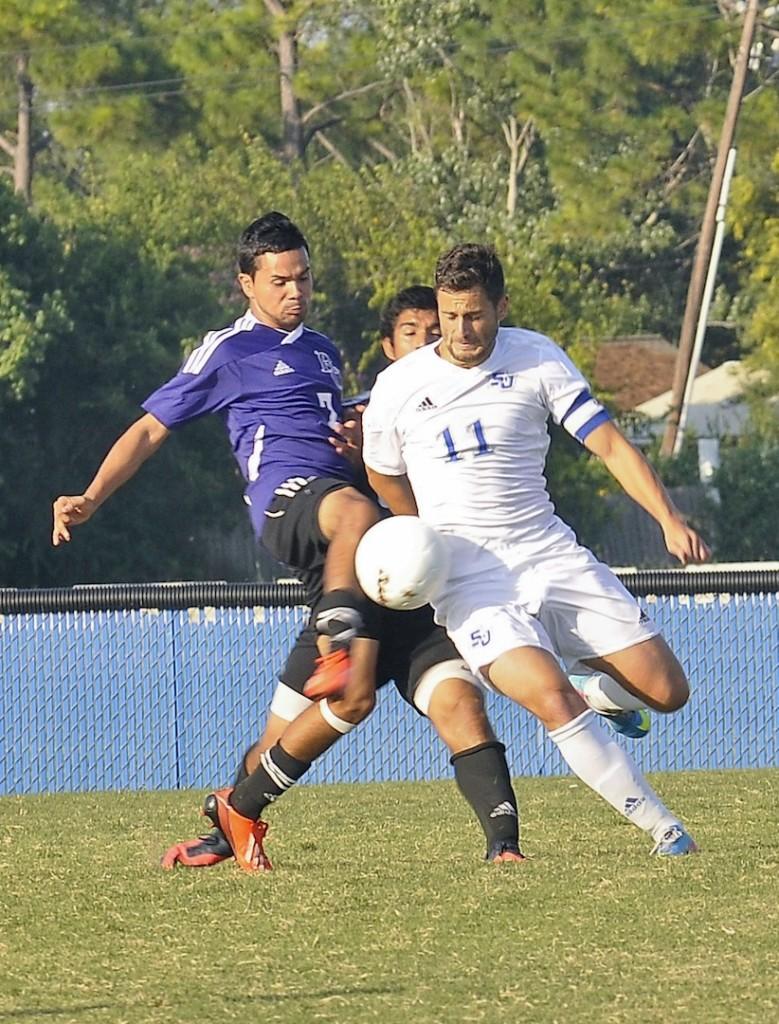Forward Sito Seoane (11) fends off a Ranger College defender to control the ball.