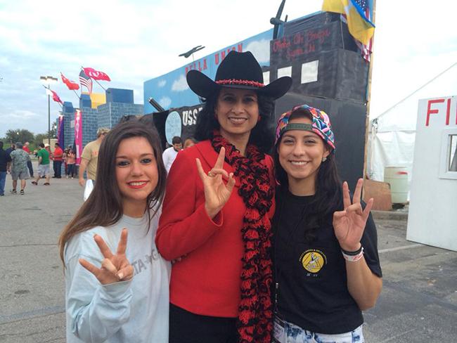 The UH leader (center) poses for a picture with Delta Gamma sisters Taylor Weaster (left) and Erika Sanchez, while showing their Cougar Pride at the University’s 2015 Frontier Fiesta. 