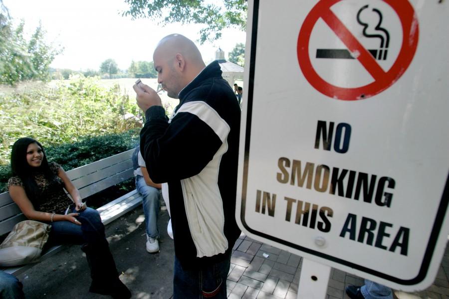 Violations+of+tobacco+bans+are+commonplace+in+higher+education.+Francisco+Altamirano+%28right%29+and+Alexandra+Budde%2C+light+up+next+to+a+no+smoking+sign+in+this+2007+photo+taken+at+Bergen+Community+College+in+Paramus%2C+New+Jersey.+%0A%0A%0A%0A