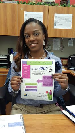 Telishia Long holds up a flyer for Women of Integrity, an organization aimed at empowering women. In support of their mission, the group will host a guest speaker for a presentation March 10 on the Central campus.