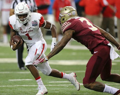 University of Houston quarterback Greg Ward Jr. runs for yardage on a quarterback keeper against Florida State defensive back Derwin James during the Chick-fil-A Peach Bowl on Dec. 31, 2015 at the Georgia Dome in Atlanta. Ward continues to lead the team through a stellar season.