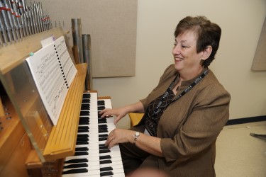 Dr. Martha Braswell plays the new Johannes Ecclesia digital organ, a gift from local music lover Dr. B.J. Westbrook.