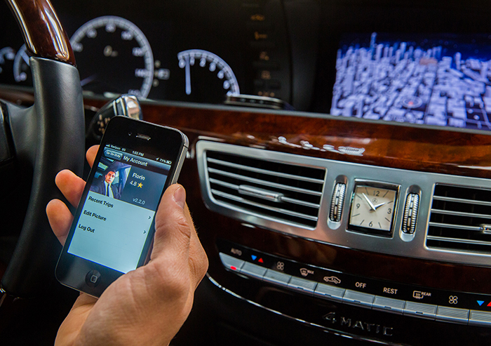 An+Uber+driver+checks+a+phone+app+to+find+his+next+fare.+The+ride-sharing+service+posts+the+promise+to+%E2%80%98Work+Around+Your+Class+Schedule%E2%80%99+on+its+website.++%0A