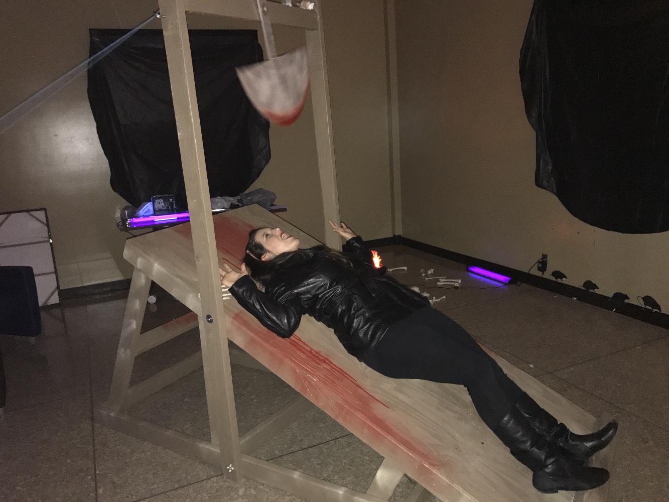 Kristen Pyeatt takes a turn at The Pit and the Pendulum booth while attending the literary arts festival hosted April 19 on the Central Campus.
