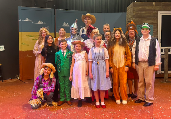 Actors in The Wizard of Oz in the Wild West standing for a group photo. 